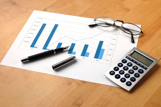 business still life with coffee and chart showing success