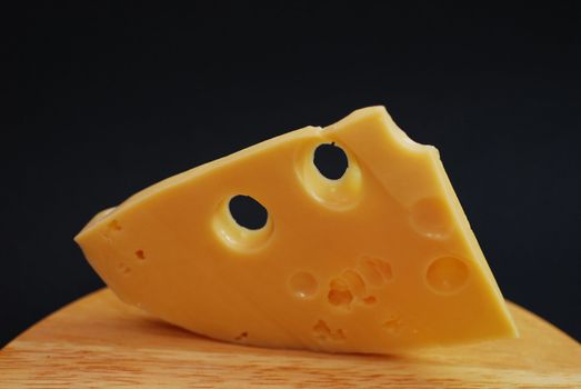 Piece of cheese on a black background