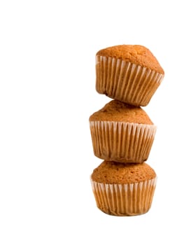 A pile of three muffins isolated over white background.