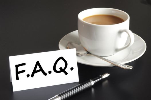 faq or frequently asked question concept with cup of coffee on black