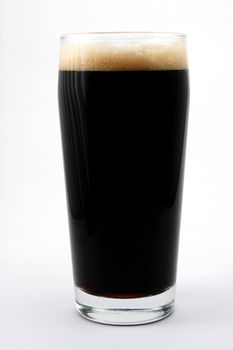 dark beer isolated on white background with foam