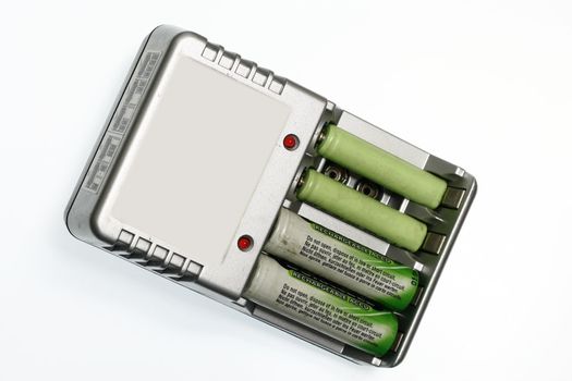 Battery Charger isolated in white with batteries