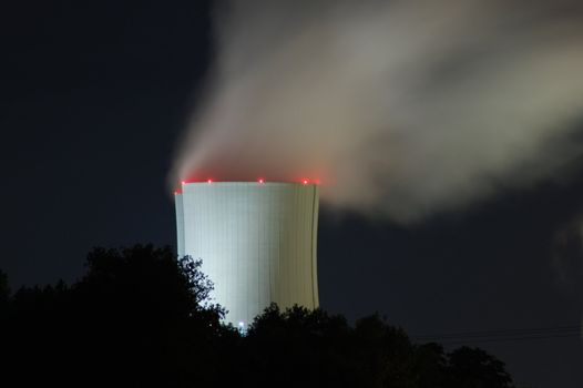 a smoking industrial power plant at night
