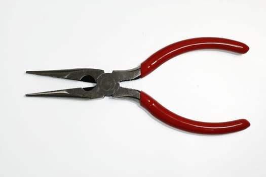 Combination pliers with red plastic handle on the white background.