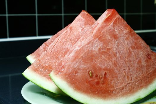 Fresh cut Watermelon in a black tile background