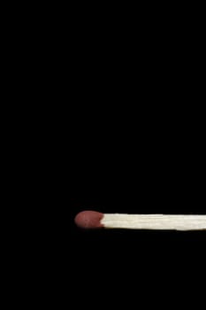 Single Wooden Matchstick With A Red Head On A Black Background
