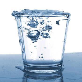 splashing water pouring in a glass with bubbles