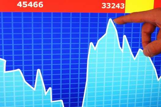 financial stock market concept with hand and computer lcd display