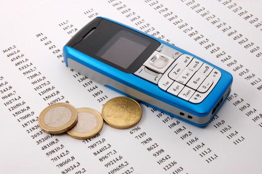 blue cell phone over business chart showing success