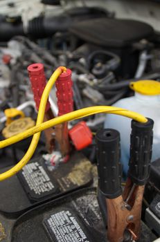 Jumper cables attached to a car battery