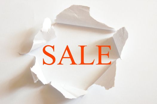 sale concept with hole in blank paper