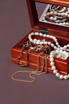 Nice wooden jewelry box on brown textile background