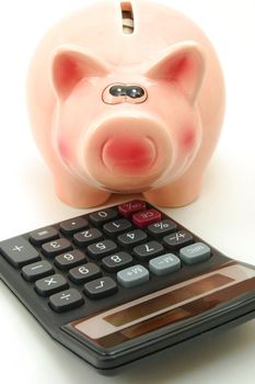 piggy bank and calculator showing saving concept