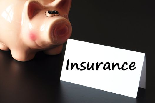 insurance concept with piggy bank and money on black background