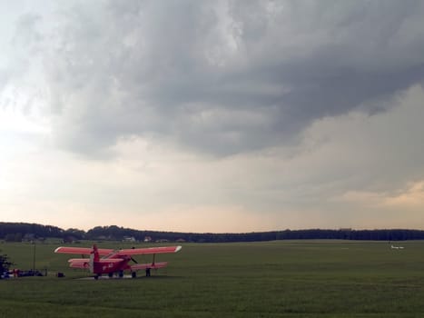 the red plane on the green grass 