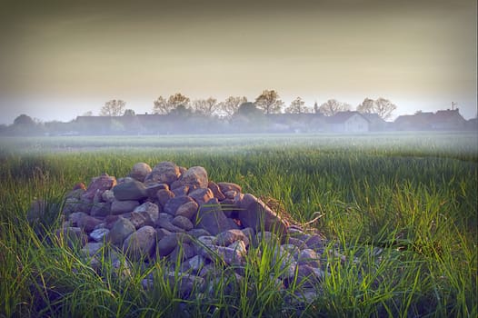 the stones in the grass near the village