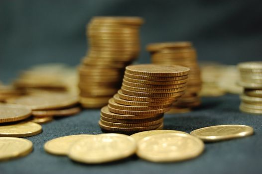 A pile of golden coins on dark background