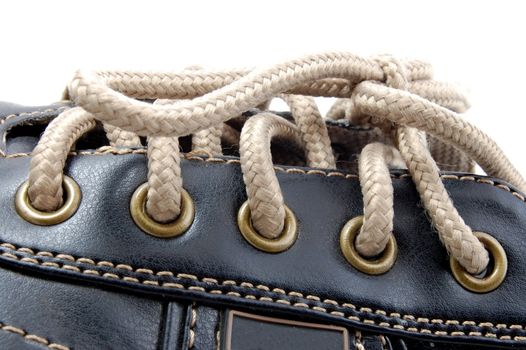 macro of a brown leather shoe and bootlace