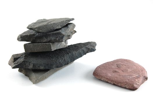 A tower made of stones isolated on a white background.