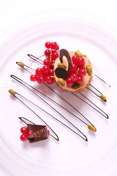 Chocolate Dessert with Nut and Berry of the Currant on Transparent Plate
