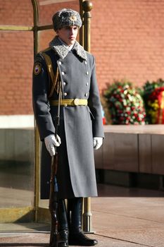 Russian soldier with the weapon, standing at attention 