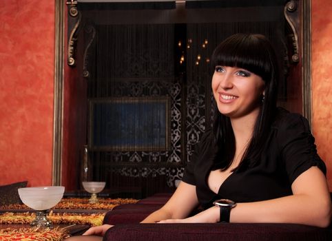 Affectionate young woman smiling in luxury restaurant