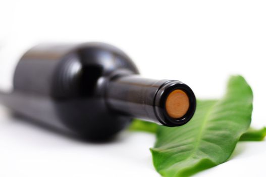 wine and copyspace on white with green leaves