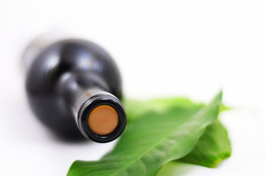 wine and copyspace on white with green leaves