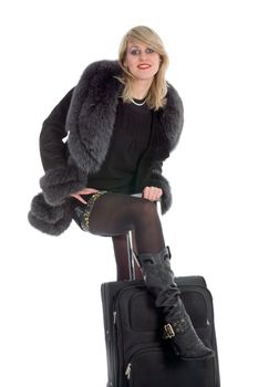 Beautiful blonde with valise on black background