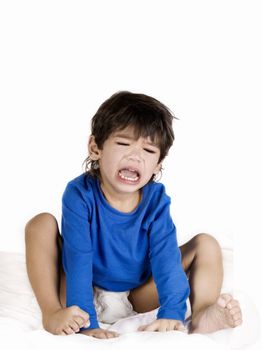 Angry crying toddler boy with diaper sitting up, disabled with cerebral palsy