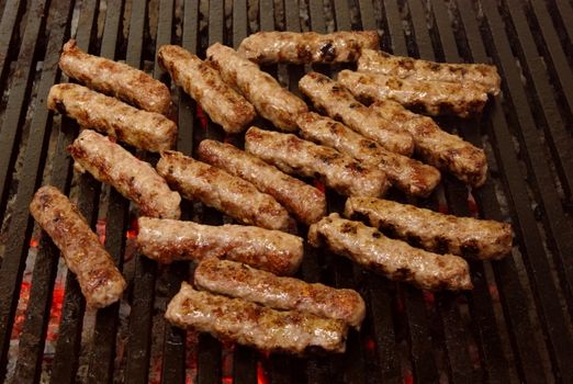 cevapcici - a sort of rolled minced beef, pork and lamb meat preparing on grill similar to Turkish kebab