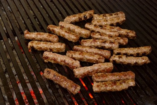 cevapcici - a sort of rolled minced beef, pork and lamb meat preparing on grill similar to Turkish kebab