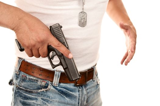 Closeup of man in t-shirt drawing gun from waist
