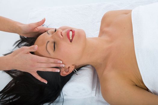 masseuse does relax facial massage to the girl