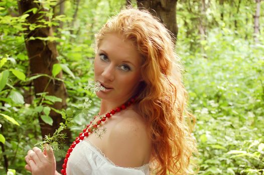 redhead in green deep woods