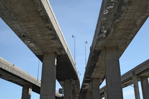 Urban highway viaducts perspective against the blue sky.