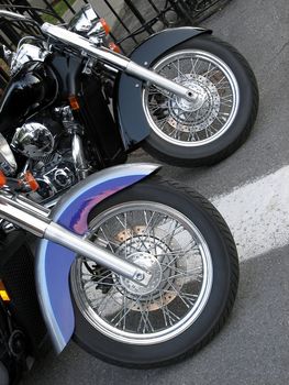 Chopper wheels. Shiny chrome and black tires.