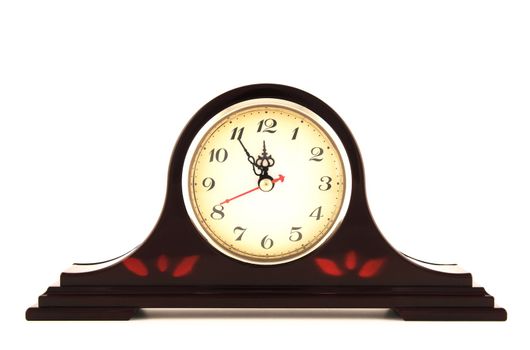Old fashioned clock showing five minutes to 12.