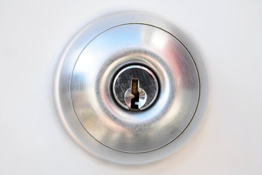 Closeup of metallic door handle with keyhole.