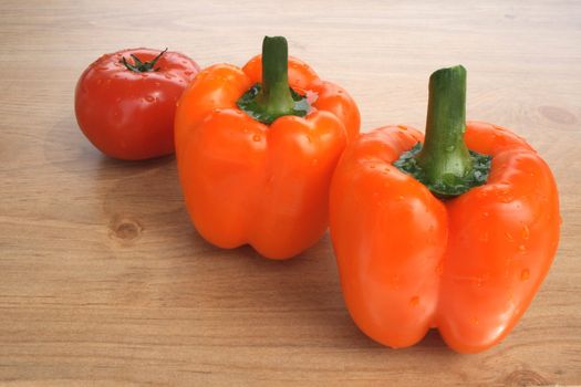 Fresh vegetables. Sweet orange peppers and tomato.