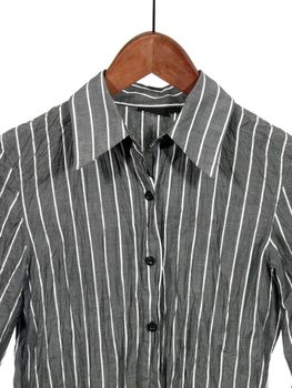 Gray striped shirt on wooden hanger, isolated on white.