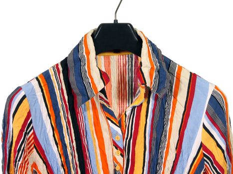 Closeup of a stylish striped shirt on black hanger, isolated on white.