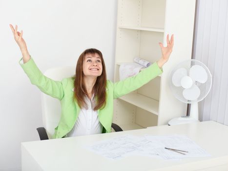 Jubilant woman at his workplace in the office