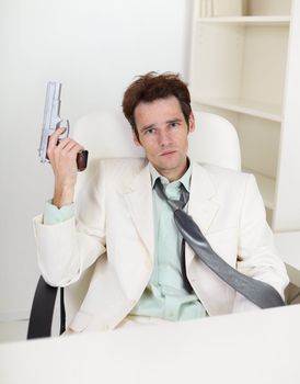 Young, strong-minded businessman with a gun in his hand