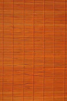 Background: warm orange color of rattan texture.