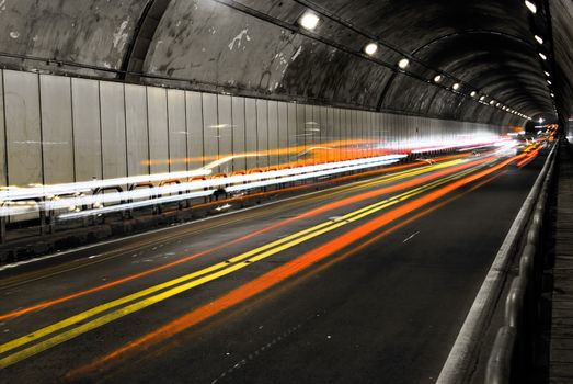 Cityscape of tunnel with color of car light.