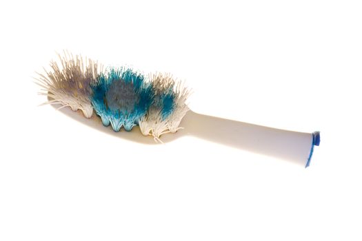 Broken toothbrush and dirty brush on white background.