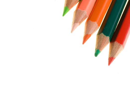 Color wooden pencils lay on white background.
