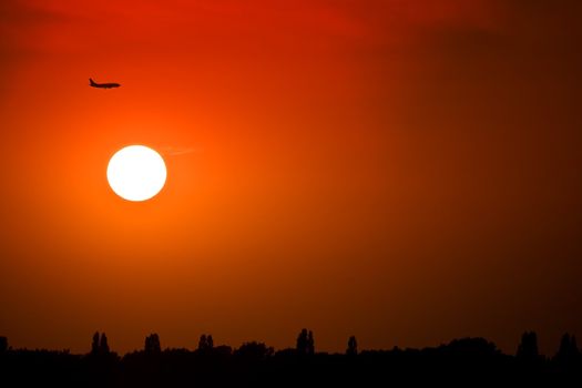 Silhouette of a plane at sunset