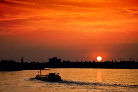 Barge with cargo at sunset